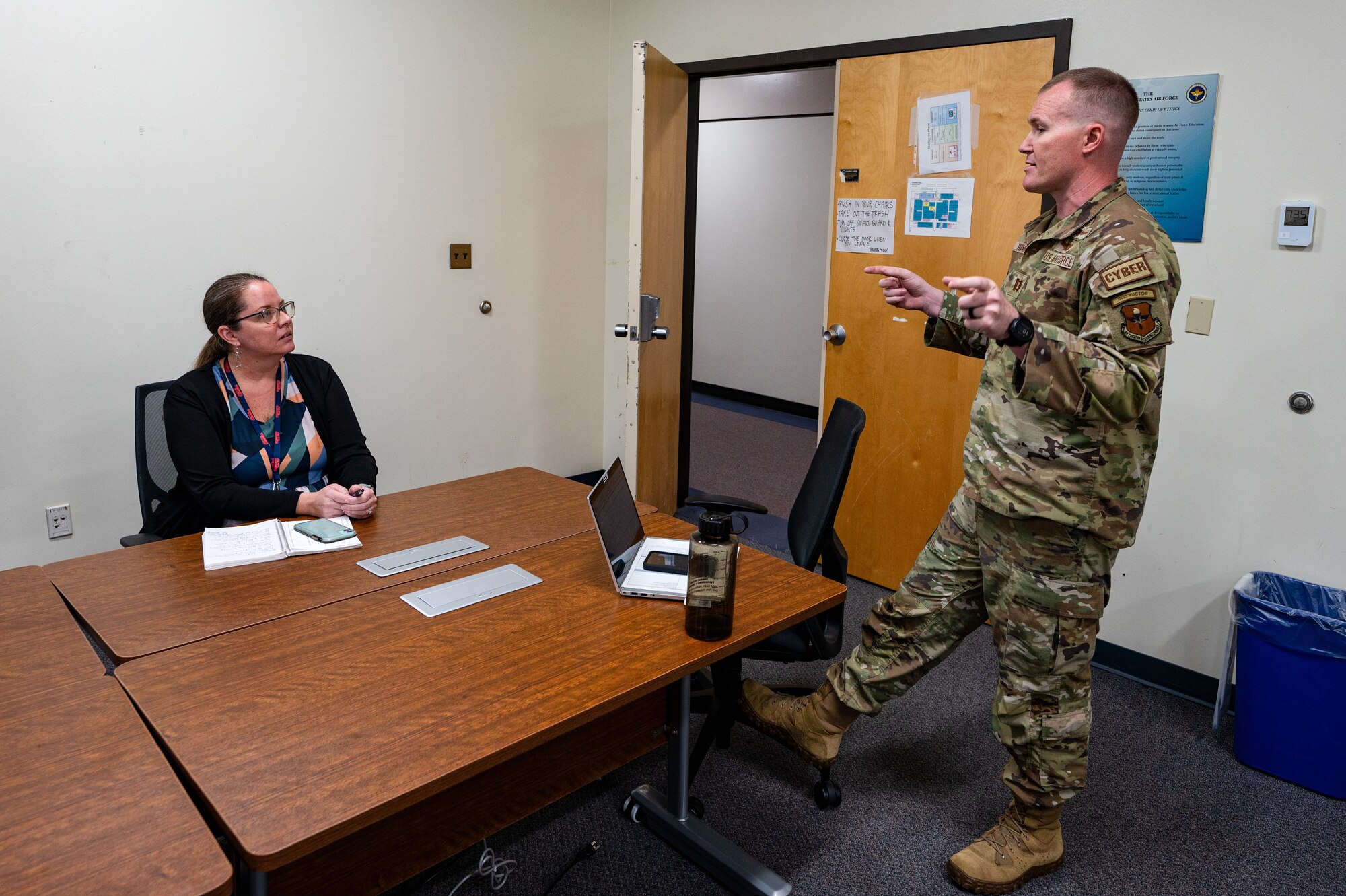 U.S. Air Force Capt. Gregory Hutchins, 333rd Training Squadron instructor, and KC Curtis, Biloxi school district instructional coach, discuss ways of delivering educational material to students at Keesler Air Force Base, Mississippi, March 18, 2024.
