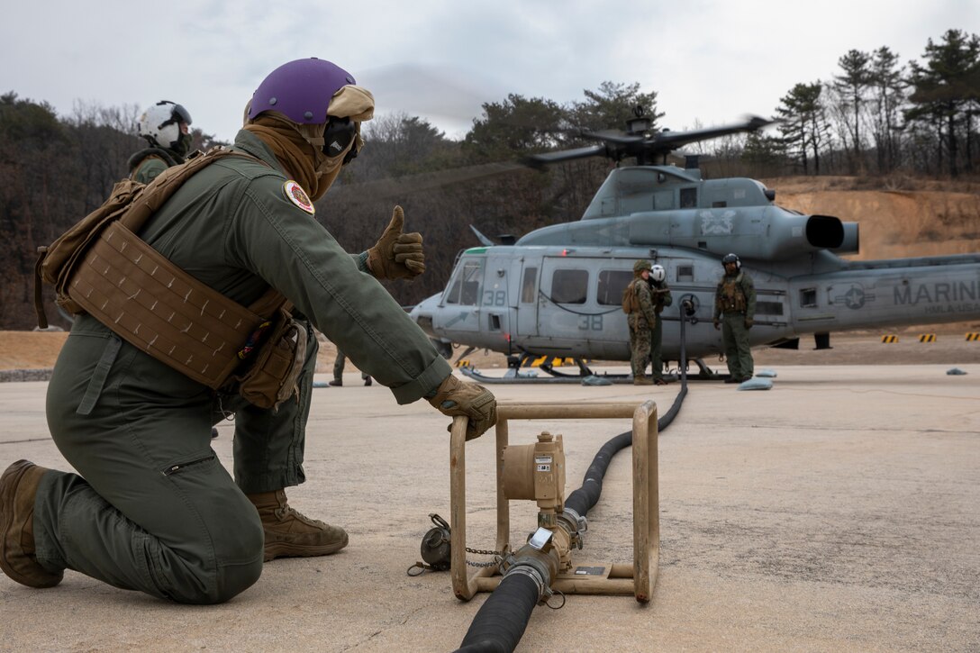 U.S. Marines with Marine Wing Support Squadron 172, Marine Aircraft Group 36, 1st Marine Aircraft Wing and Marine Light Attack Helicopter Squadron 369, Marine Aircraft Group 39, 3rd MAW, refuel a UH-1Y Venom helicopter at a forward arming and refueling point at Rodriguez Live Fire Range Complex, Pocheon, South Korea, March 11, 2024. Marines with Marine Air Control Squadron 4, MWSS-172, and 3rd Low Altitude Air Defense Battalion came together to execute a fortified FARP during Warrior Shield 24. Warrior Shield 24 is an annual joint, combined exercise held on the Korean Peninsula that seeks to strengthen the combined defensive capabilities of Republic of Korea and U.S. forces. This routine, regularly scheduled, field training exercise provides the ROK and U.S. Marines the opportunity to rehearse combined operations, exchange knowledge, and demonstrate the strength and capabilities of the ROK-US Alliance. (U.S. Marine Corps photo by Cpl. Tyler Harmon)