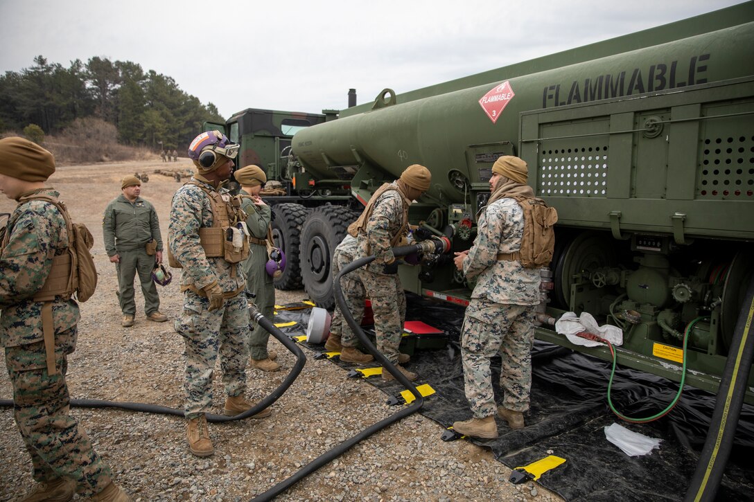 U.S. Marines with Marine Wing Support Squadron 172, Marine Aircraft Group 36, 1st Marine Aircraft Wing, prepare a fuel hose for forward arming and refueling point operations at Rodriguez Live Fire Range Complex, Pocheon, South Korea, March 11, 2024. Marines with Marine Air Control Squadron 4, MWSS-172, and 3rd Low Altitude Air Defense Battalion came together to execute a fortified FARP during Warrior Shield 24. Warrior Shield 24 is an annual joint, combined exercise held on the Korean Peninsula that seeks to strengthen the combined defensive capabilities of Republic of Korea and U.S. forces. This routine, regularly scheduled, field training exercise provides the ROK and U.S. Marines the opportunity to rehearse combined operations, exchange knowledge, and demonstrate the strength and capabilities of the ROK-US Alliance. (U.S. Marine Corps photo by Cpl. Tyler Harmon)
