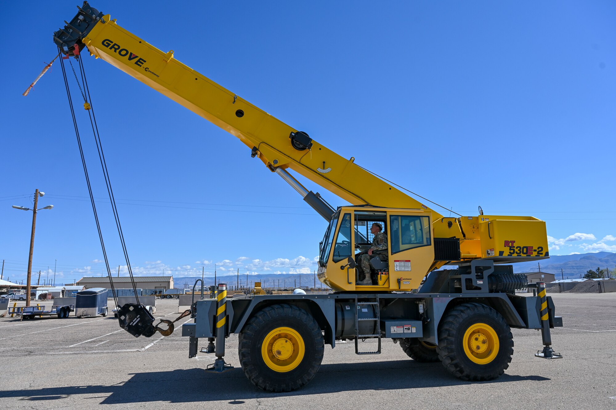 U.S. Air Force Staff Sgt. Kevin Alvaran, 49th Civil Engineer Squadron pavement and equipment craftsman, maneuvers a 30-ton crane at Holloman Air Force Base, New Mexico, March 21, 2024. The Dirt Boyz of the 49th CES are known for their constant interaction with heavy construction equipment and hand tools used to repair and maintain Holloman’s roads, airfield, fences, and drainage systems. (U.S. Air Force photo by Airman 1st Class Michelle Ferrari)