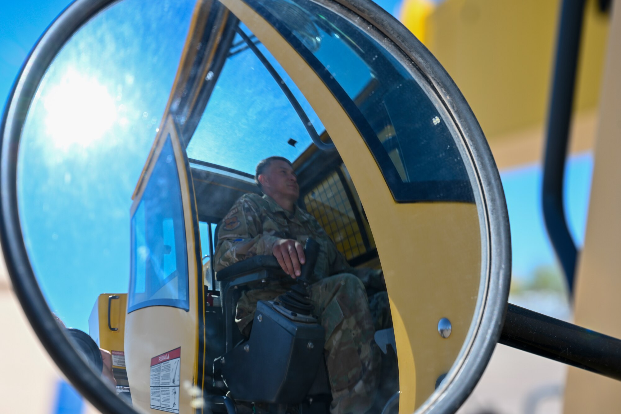 U.S. Air Force Staff Sgt. Kevin Alvaran, 49th Civil Engineer Squadron pavement and equipment craftsman, maneuvers a 30-ton crane at Holloman Air Force Base, New Mexico, March 21, 2024. Known affectionately as Dirt Boyz, these Airmen perform a variety of tasks, including foreign object debris sweeps, patchwork on roads, parking lots, and runways, placement of gravel and dirt and trench excavation for electrical and plumbing lines. (U.S. Airforce photo by Airman 1st Class Michelle Ferrari)