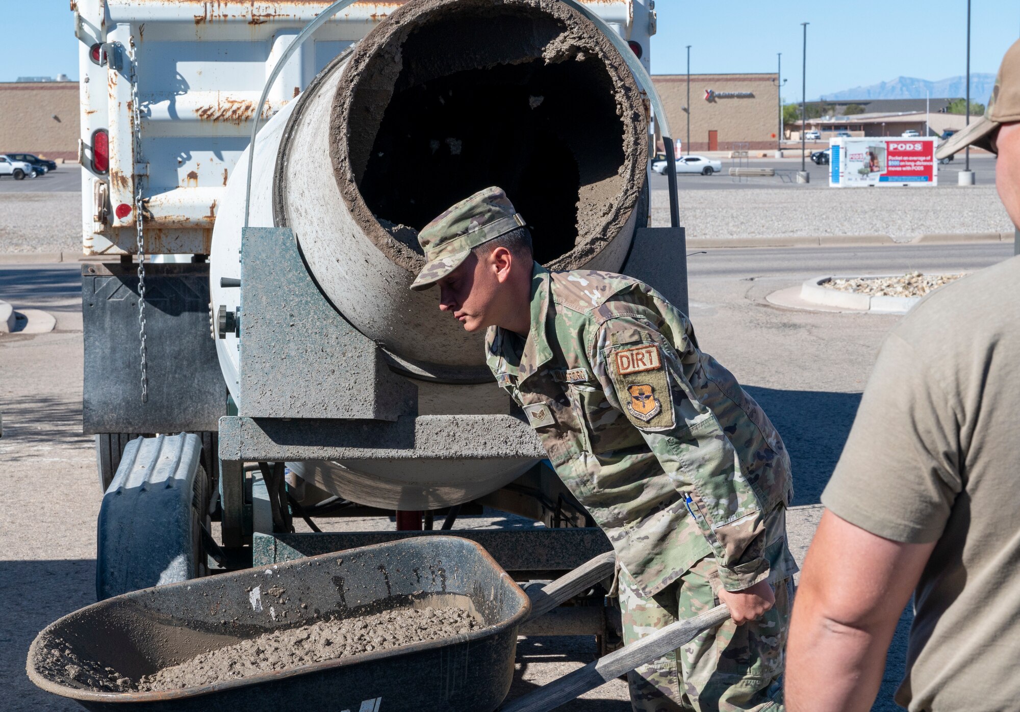U.S. Air Force Staff Sgt. Kevin Alvaran, 49th Civil Engineer Squadron pavement and equipment craftsman, uses a wheelbarrow to transport cement at Holloman Air Force Base, New Mexico, March 22, 2024.  Known affectionately as Dirt Boyz, these Airmen perform a variety of tasks, including foreign object debris sweeps, patchwork on roads, parking lots, and runways, placement of gravel and dirt and trench excavation for electrical and plumbing lines. (U.S. Airforce photo by Airman 1st Class Michelle Ferrari)