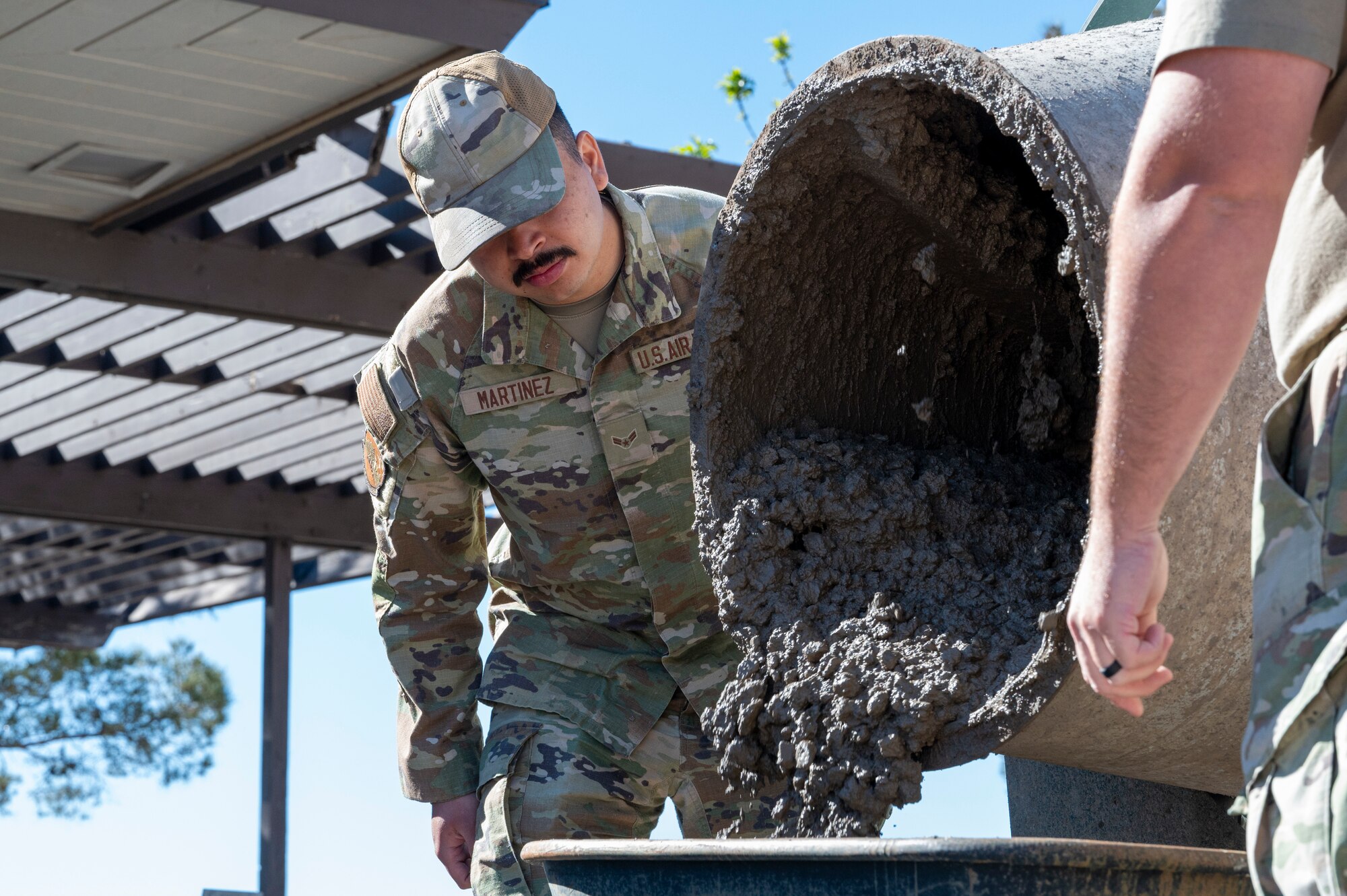 U.S. Air Force Airman 1st Class Angel Martinez, 49th Civil Engineer Squadron pavement and heavy equipment operator, pours cement into a wheelbarrow at Holloman Air Force Base, New Mexico, March 22, 2024. The Dirt Boyz of the 49th CES are known for their constant interaction with heavy construction equipment and hand tools used to repair and maintain Holloman’s roads, airfield, fences, and drainage systems. (U.S. Air Force photo by Airman 1st Class Michelle Ferrari)