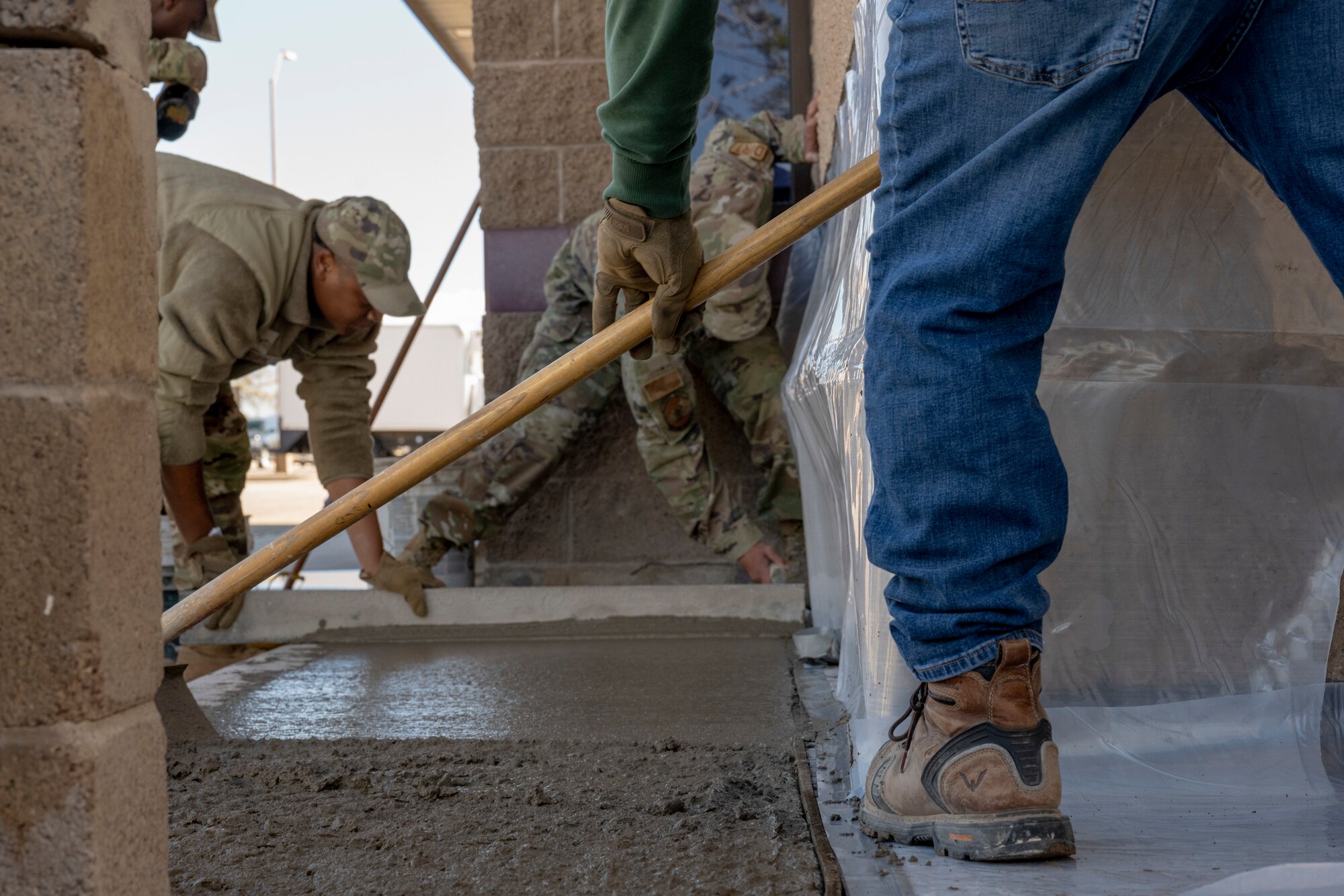 Dirt Boyz members of the 49th Civil Engineer Squadron, fill a sidewalk with cement at Holloman Air Force Base, New Mexico, March 22, 2024. Members of the Dirt Boyz are responsible for maintaining Holloman’s infrastructure by using various tools to complete construction projects. (U.S. Air Force photo by Airman 1st Class Michelle Ferrari)