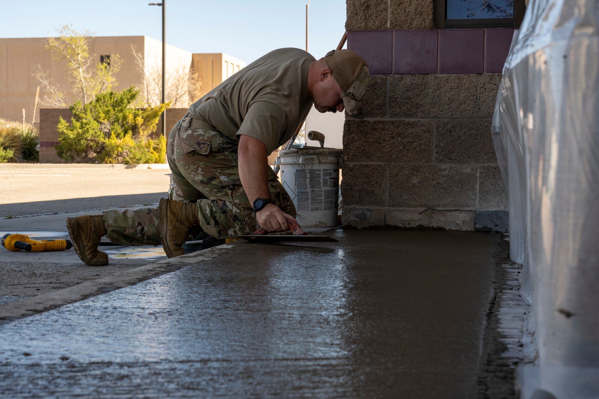 U.S. Air Force Staff Sgt. Elliot Westerman, 49th Civil Engineer Squadron pavement and heavy equipment operator craftsman, levels cement filling at Holloman Air Force Base, New Mexico, March 22, 2024.  Known affectionately as Dirt Boyz, these Airmen perform a variety of tasks, including foreign object debris sweeps, patchwork on roads, parking lots, and runways, placement of gravel and dirt and trench excavation for electrical and plumbing lines. (U.S. Airforce photo by Airman 1st Class Michelle Ferrari)