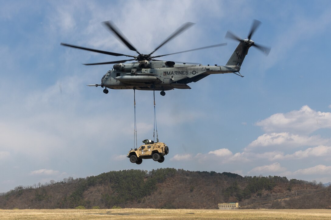 A U.S. Marine Corps CH-53E Super Stallion helicopter assigned to Marine Heavy Helicopter Squadron (HMH) 466, Marine Aircraft Group 36, 1st Marine Aircraft Wing lifts a Joint Light Tactical Vehicle during Warrior Shield 24, at Drop Zone Dangmali, South Korea, March 20, 2024. Warrior Shield 24 is an annual joint, combined exercise held on the Korean Peninsula that seeks to strengthen the combined defensive capabilities of ROK and U.S. forces. This routine, regularly scheduled, field training exercise provides the ROK and U.S. Marines the opportunity to rehearse combined operations, exchange knowledge, and demonstrate the strength and capabilities of the ROK-US Alliance. (U.S. Marine Corps photo by Cpl. Kyle Chan)