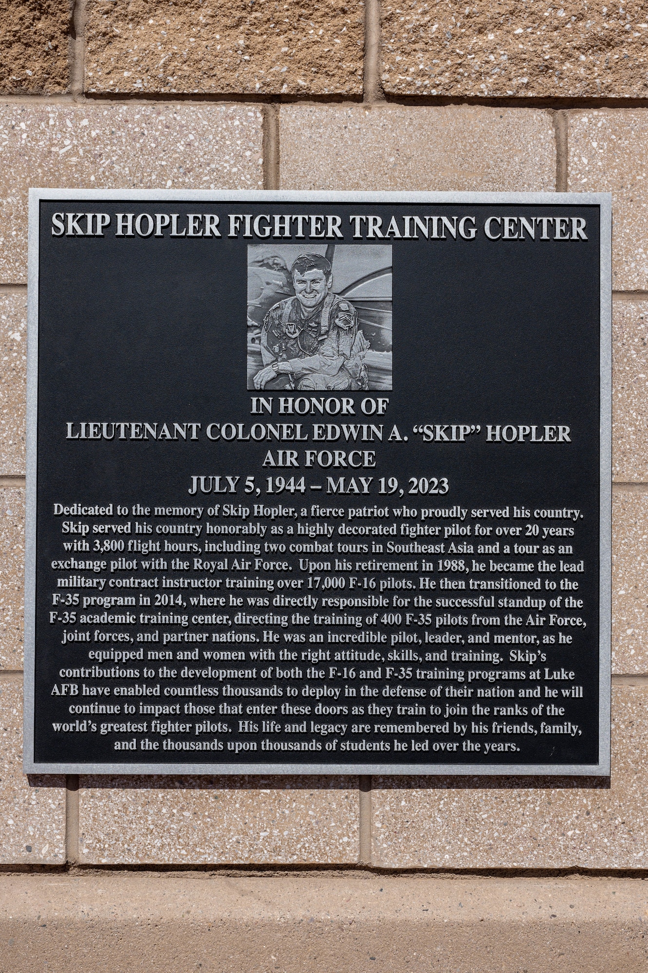 A remembrance plaque is unveiled during the renaming ceremony of the Skip Hopler Fighter Training Center, March 29, 2024, at Luke Air Force Base, Arizona.