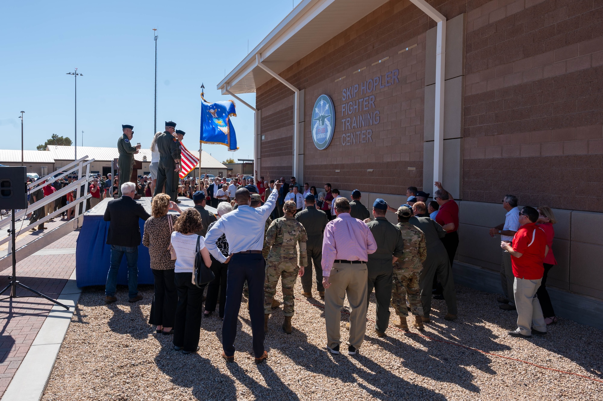 “A nickel on the grass toast” is held during the renaming ceremony of the Skip Hopler Fighter Training Center, March 29, 2024, at Luke Air Force Base, Arizona.