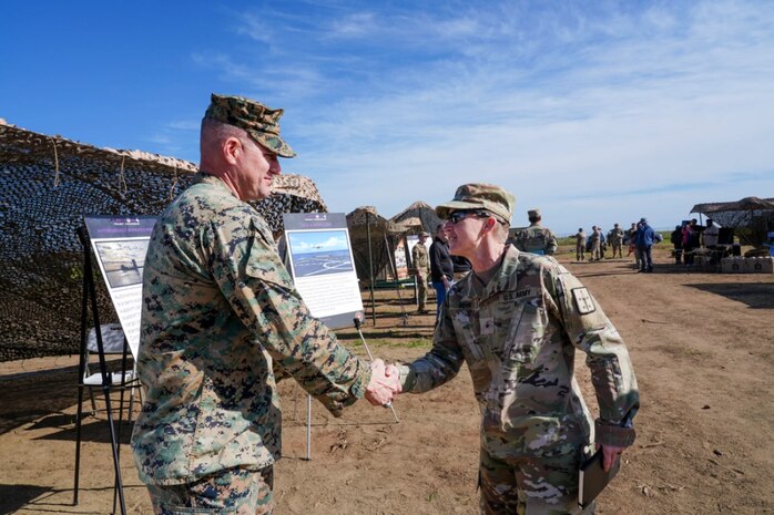 US Marine Corps Lt. Col. Timothy J. Smith, Marine Corps Warfighting Laboratory Science and Technology Logistics Combat Element branch head, receives the US Army Transportation School Chief of Transportation’s Coin from US Army Brig. Gen. Beth A. Behn, US Army Transportation School chief of transportation, for his work regarding Marine Corps capabilities during Project Convergence Capstone 4, March 5, 2024 at Camp Pendleton, CA.

PC-C4 is an Army-hosted, all-Service and multinational experiment. During PC-C4, the Marine Corps Warfighting Laboratory tested new technologies and capabilities and emerging concepts, including the multi-domain corridor. The Marine Corps’ participation in PC-C4 supported Force Design initiatives, integrated Joint force and Coalition capabilities into experimentation, and demonstrated the Marine Corps' commitment to the Joint Warfighting Concept. (US Marine Corps photo by Kevin Ray J. Salvador)