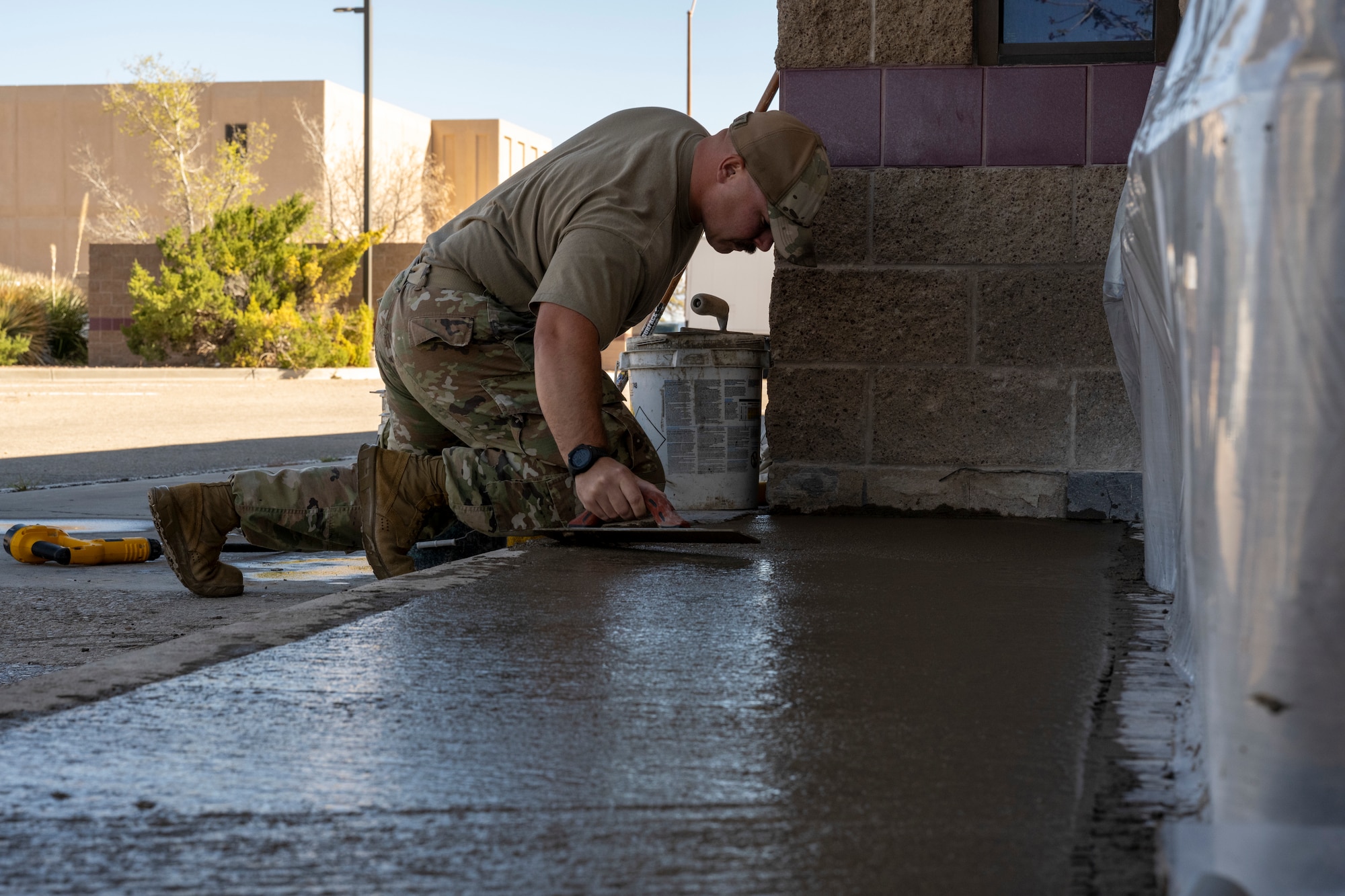 U.S. Air Force Staff Sgt. Elliot Westerman, 49th Civil Engineer Squadron pavement and heavy equipment operator craftsman, levels cement filling at Holloman Air Force Base, New Mexico, March 22, 2024.  Known affectionately as Dirt Boyz, these Airmen perform a variety of tasks, including foreign object debris sweeps, patchwork on roads, parking lots, and runways, placement of gravel and dirt and trench excavation for electrical and plumbing lines. (U.S. Airforce photo by Airman 1st Class Michelle Ferrari)