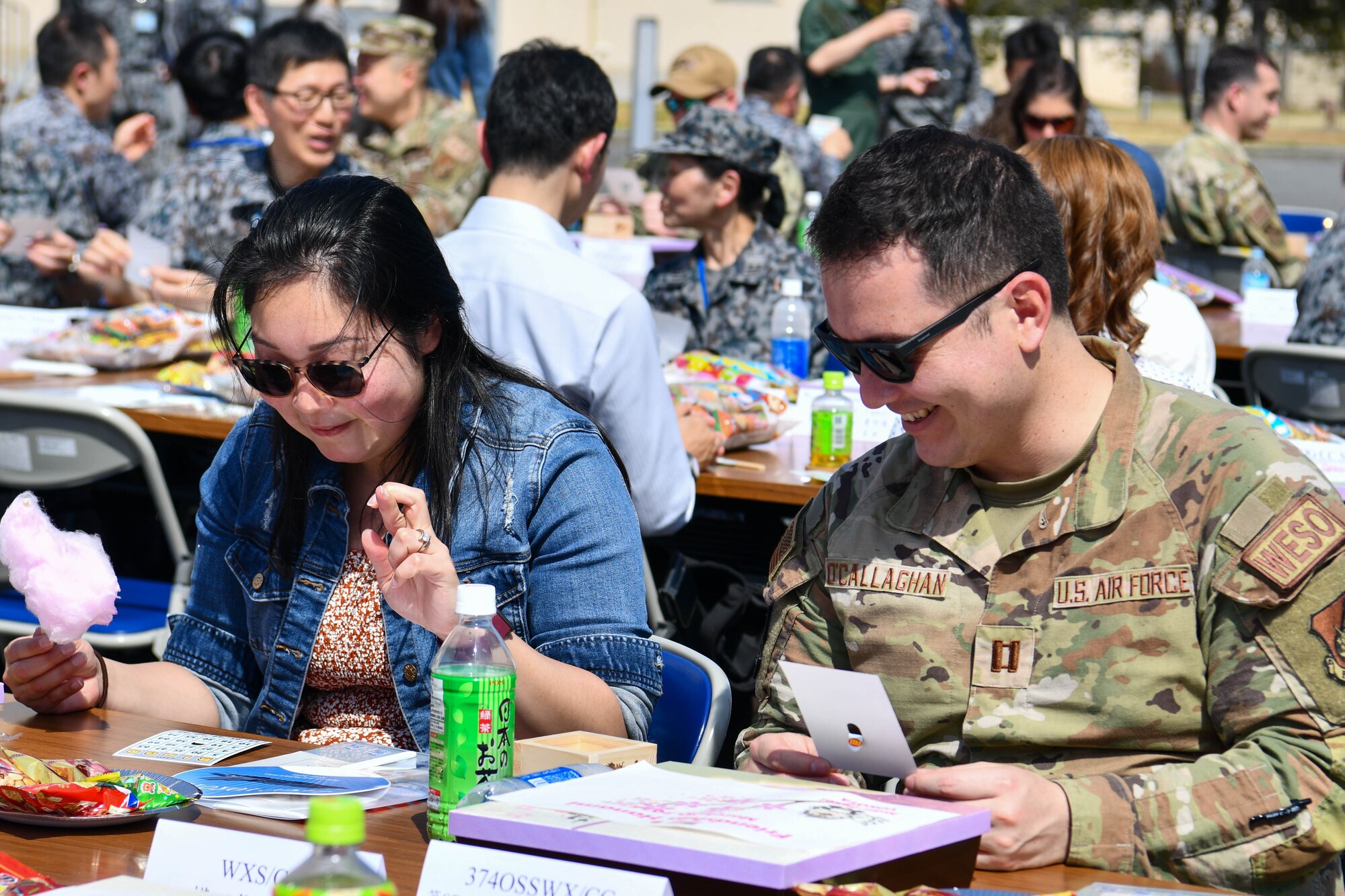 Shannon O’Callaghan, staff judge advocate secretary, and U.S. Air Force Capt. Kevin O’Callaghan, 374th Operational Support Squadron weather flight commander, participate in a bingo game.
