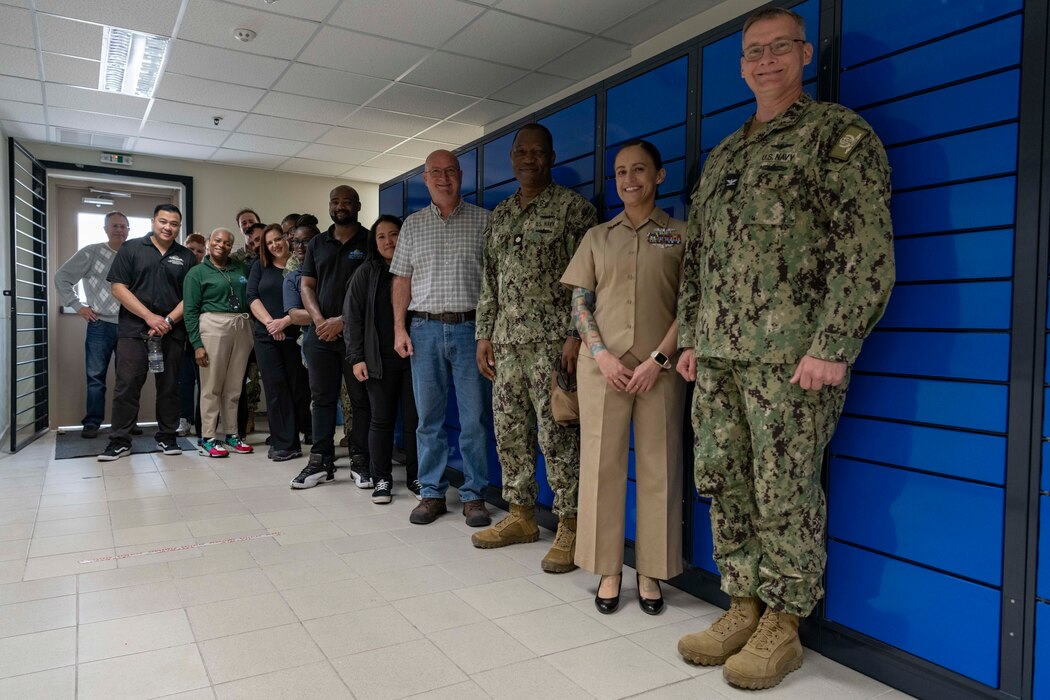 Personnel assigned to Naval Support Activity Souda Bay and Naval Supply Systems Command Fleet Logistics Center (NAVSUP FLC) Sigonella attend a ribbon cutting ceremony for an automated package retrieval system on March 28, 2023.