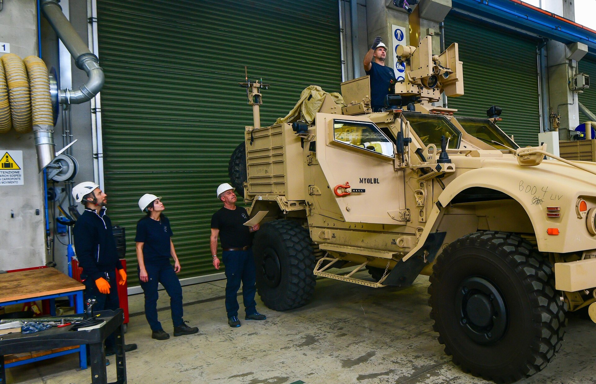 Linda Eckley, the chief of quality assurance at Army Field Support Battalion-Africa in Livorno, Italy, and her team inspect a common remotely operated weapon station on a mine-resistant ambush protected vehicle at the Leghorn Army Depot Army Prepositioned Stocks-2 worksite, April 2. (Photo by Elena Baladelli. VI-Team Livorno)