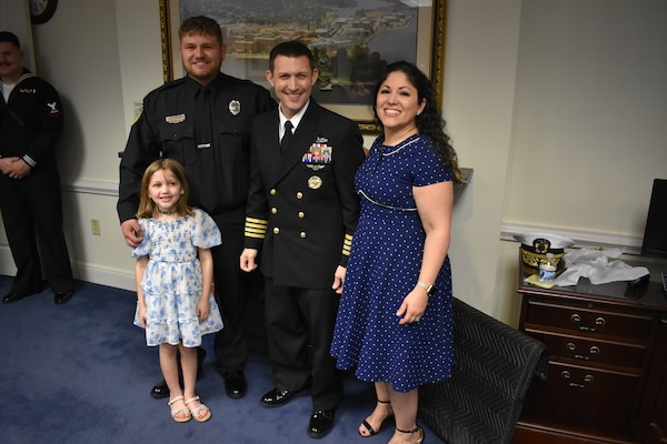 The Barnes family pause from the celebration after they helped Capt. Christopher Barnes shed his commander bars and don the uniform of a Navy captain.