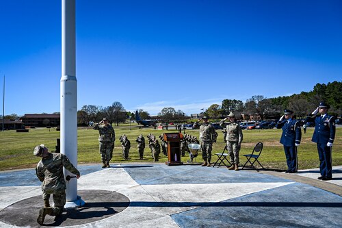 Airman  lowers the flag during a ceremony