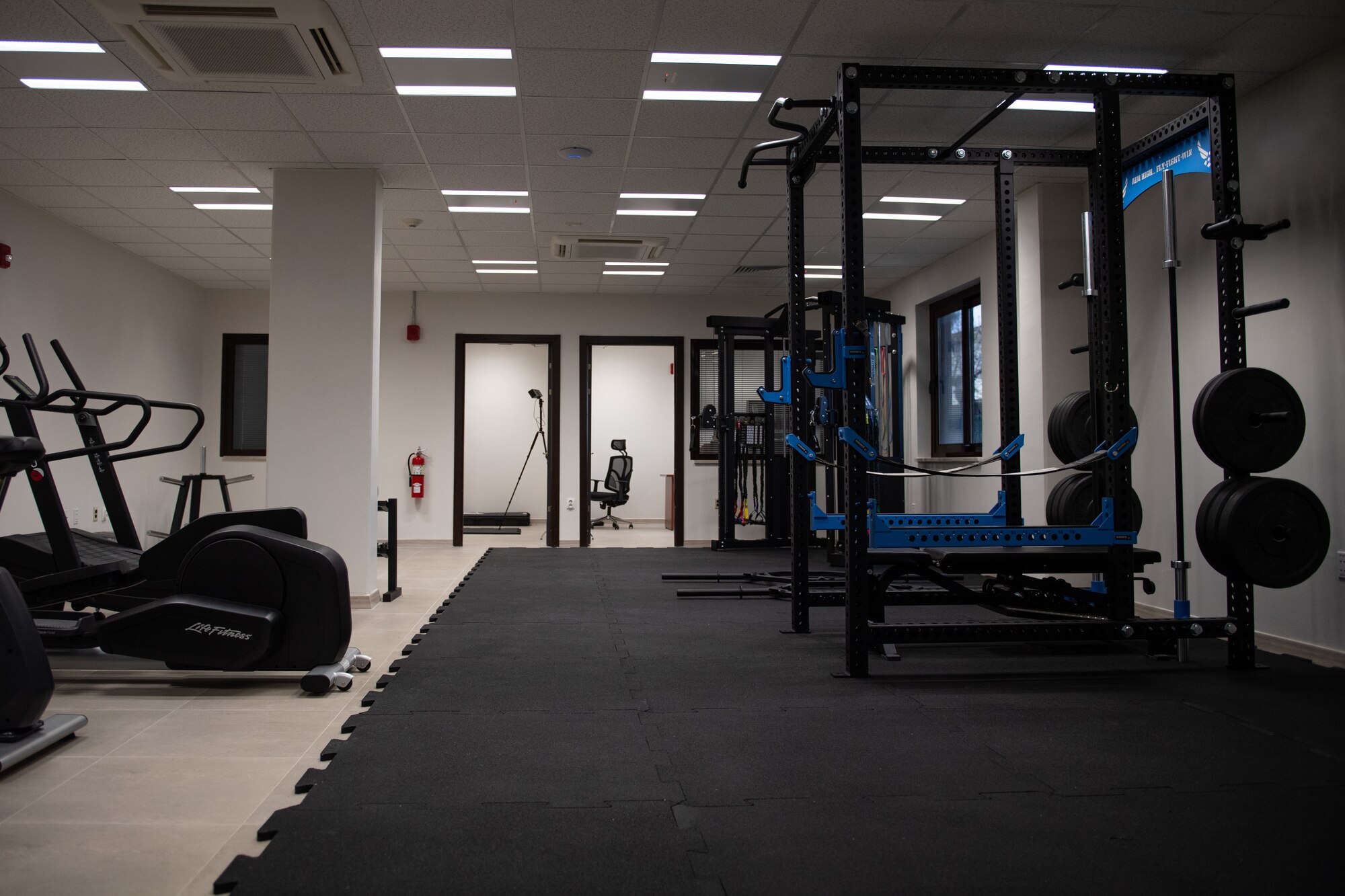 Exercise equipment is displayed inside the new Operational Support Team building at Incirlik Air Base, Türkiye, March 27, 2024. There is a squat rack, treadmill and an elliptical.