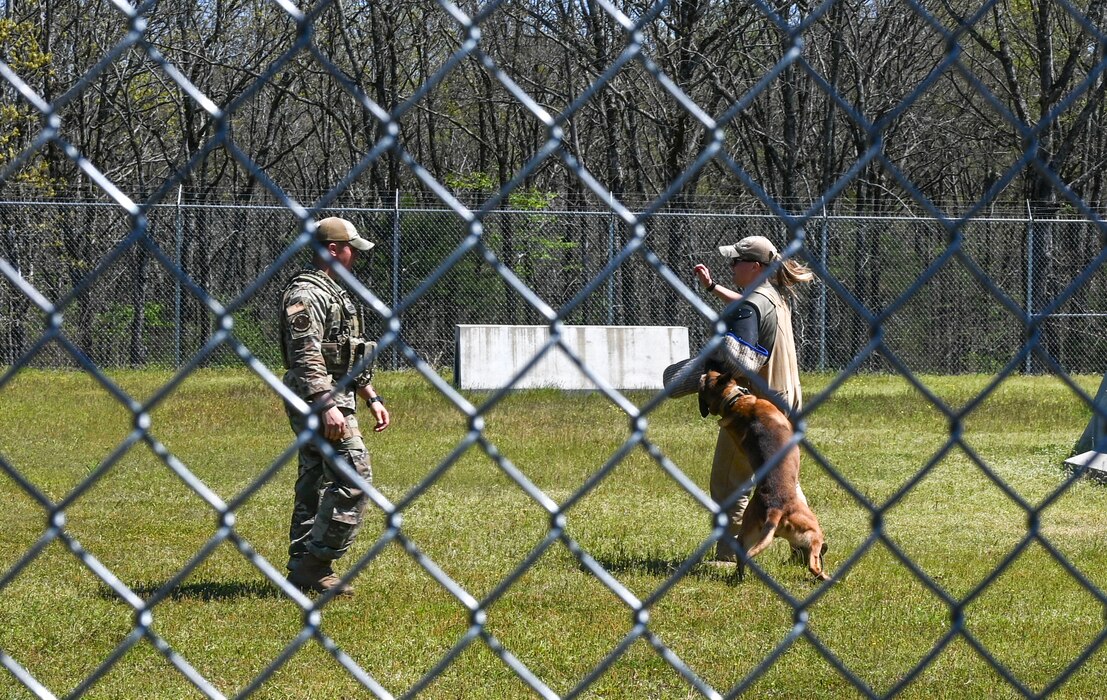 Security Forces Airmen demonstrate a training scenario with a military working dog