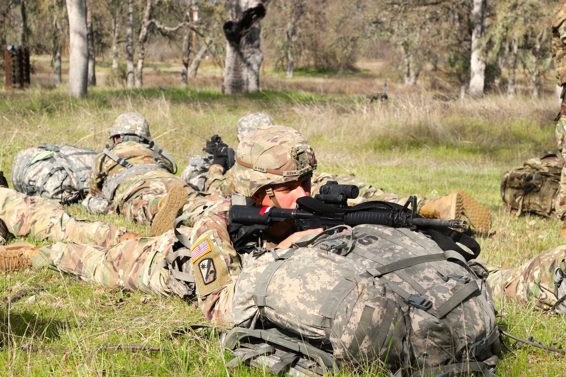 Staff Sgt. Roger Dyer and the Best Squad Competition Competitors simulate pulling security while waiting for further instructions. Five members of the 80th Training and its three divisions joined together to compete in the 2024 Best Squad competition hosted by the 63rd Readiness Division in Camp Parks and Fort Hunter Liggett, Ca.
