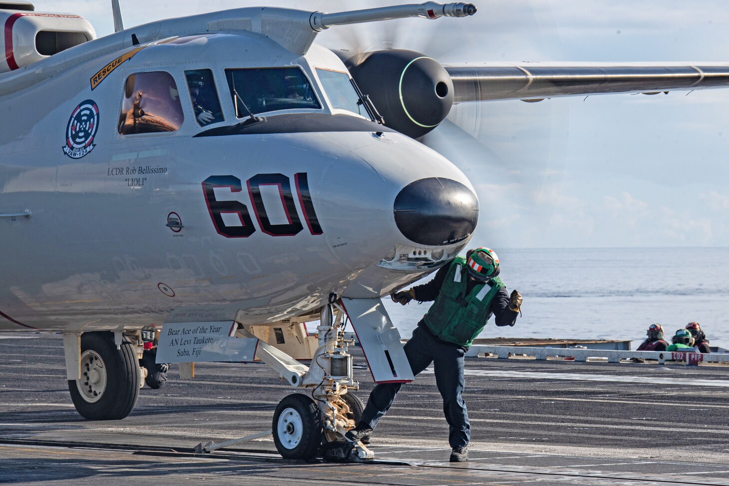 Aviation Boatswain's Mate (Equipment) 2nd Class Hunter Athey, assigned to the air department of the world’s largest aircraft carrier USS Gerald R. Ford (CVN 78), sets tension on an E-2D Hawkeye, attached to the "Bear Aces" of Airborne Command and Control Squadron (VAW) 124, on the flight deck, Dec. 11, 2023. The Gerald R. Ford Carrier Strike Group is currently operating in the Mediterranean Sea, at the direction of the Secretary of Defense. The U.S. maintains forward deployed, ready, and postured forces to deter aggression and support security and stability around the world.