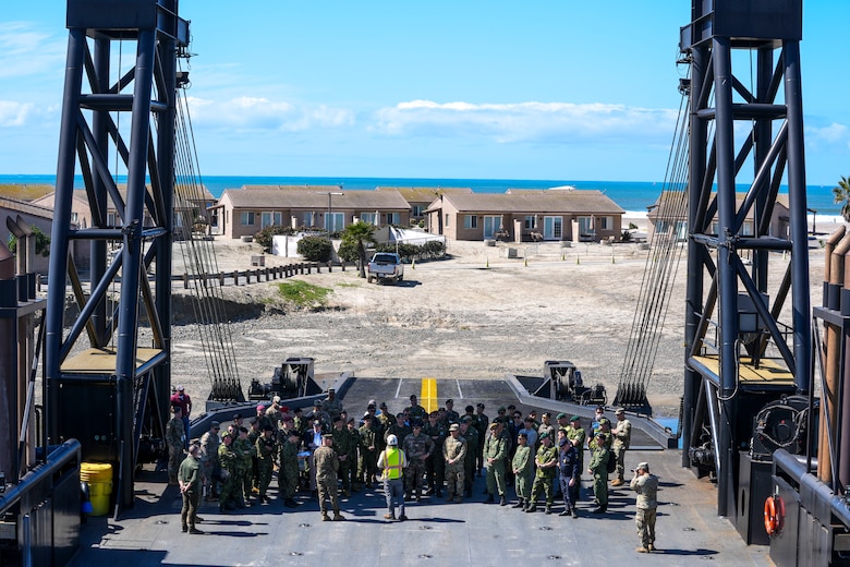 Members of the Demonstration & Assessment Team Battle Laboratory Division brief US Marines, civilian contractors, and foreign military leadership regarding the Stern Landing Vessel, a modified oil-rig industry off-shore support vessel, in order to inform them of potential safety hazards as part of Project Convergence Capstone 4, March 5, 2024 at the Del Mar Boat Basin, Camp Pendleton, CA. PC-C4 provided a unique opportunity for multiple Services and allies and partners to test the interoperability and integration of technologies and systems critical for responding to global contingencies and crises. PC-C4 is an Army-hosted, all-Service and multinational experiment. During PC-C4, the Marine Corps Warfighting Laboratory tested new technologies and capabilities and emerging concepts, including the multi-domain corridor. The Marine Corps’ participation in PC-C4 supported Force Design initiatives, integrated Joint force and Coalition capabilities into experimentation, and demonstrated the Marine Corps' commitment to the Joint Warfighting Concept.