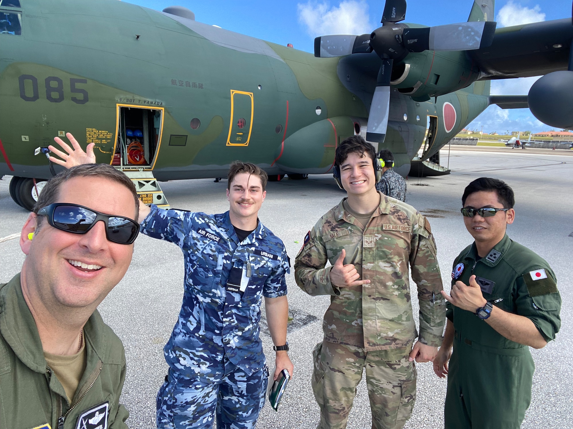 Col. Edward Schierberl, 374th Air Expeditionary Wing commander, and members of the Royal Australian Air Force, U.S Air Force and Japanese Self-Defense Force pose for a photo in February 2024, on the flightline at Andersen Air Force Base, Guam during the Cope North 24 exercise.