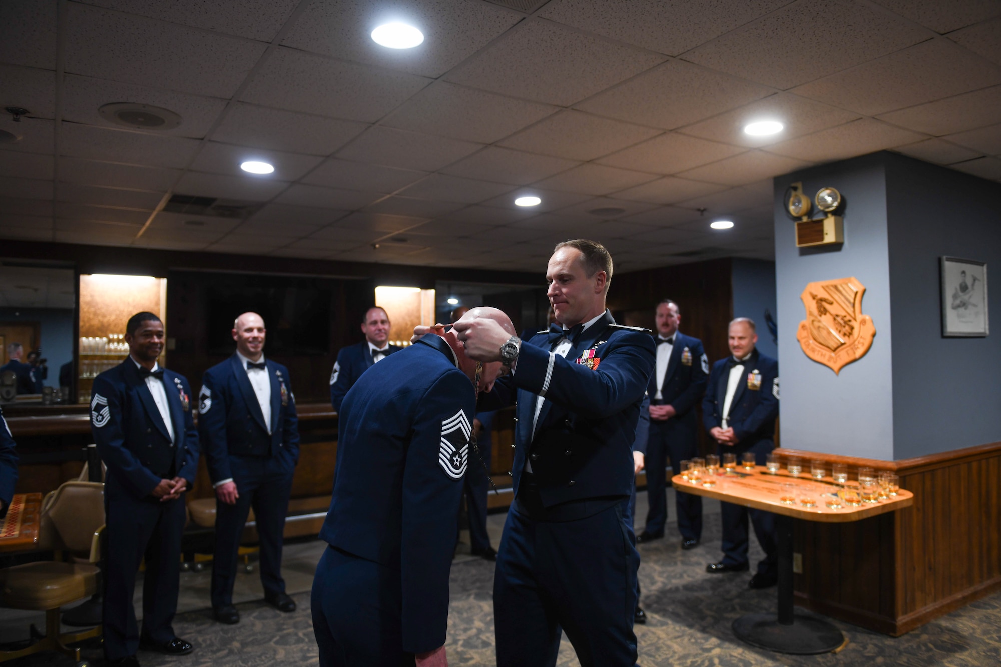 U.S. Air Force Col. Lucas Teel, 4th Fighter Wing commander, places a medallion on  Chief Master Sgt. Karl Rehkamp, select, with the 916th Maintenance Group, during a chief master sergeant recognition ceremony at Seymour Johnson Air Force Base, North Carolina, March 2, 2024. Seymour Johnson AFB leadership recognized three senior noncommissioned officers who achieved the final milestone of their rank progression. (U.S. Air Force photo by Senior Airman Taylor Hunter)