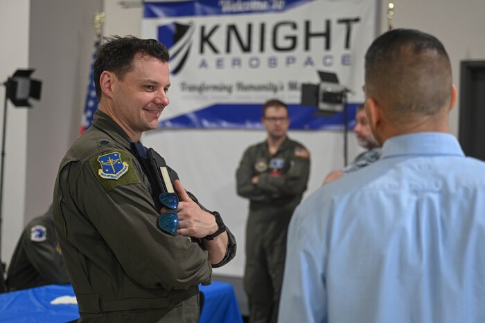 An Air Force officer talks to a contractor