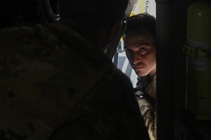 An Airman looks inside an aircraft