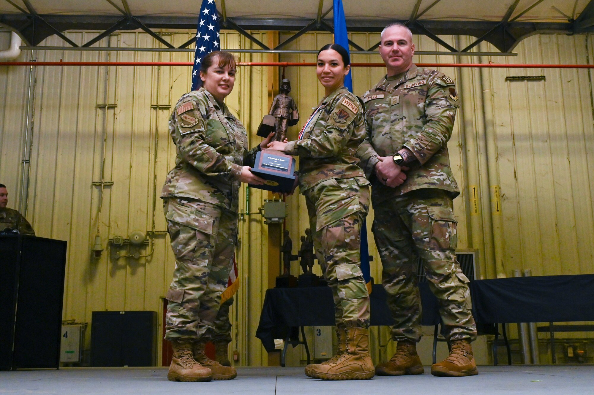 Senior Airman Sierrah Ranis, assigned to the 333rd Fighter Generation Squadron, receives the Lt. General Leo Marquez award from Col. Kathryn Roman, 4th Maintenance Group commander and Chief Master Sgt. Michael Bylica, 4 MXG senior enlisted leader, during the 4 MXG Maintenance Person of the Year ceremony at Seymour Johnson Air Force Base, North Carolina, Mar. 08, 2024. The 4th Maintenance Group hosts the event annually for MXG Airmen to celebrate their achievements and hard work. (U.S. Air Force photo by Airman Rebecca Tierney)