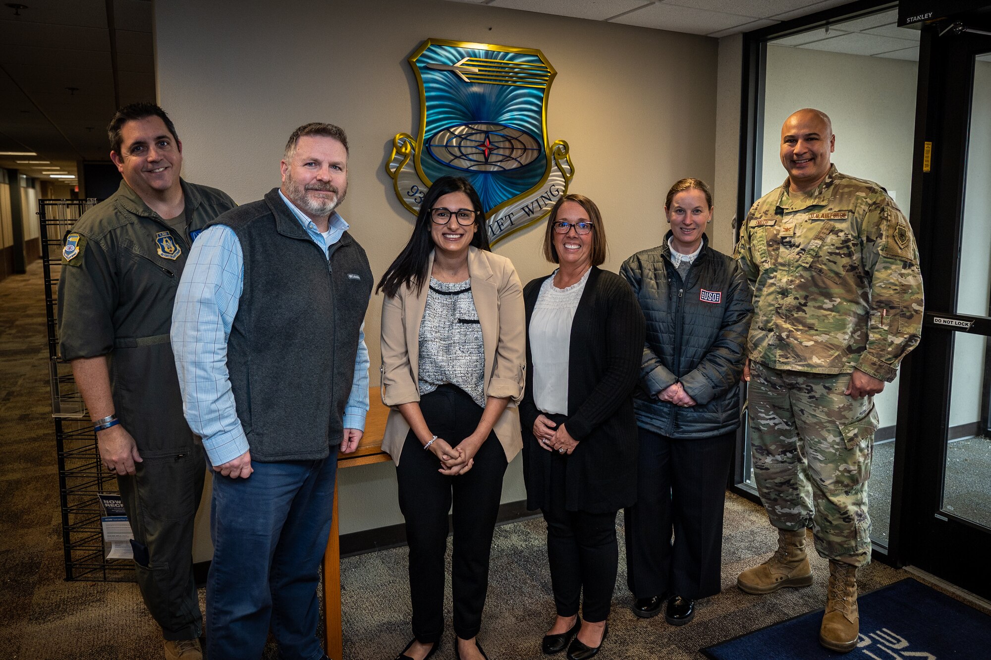 Megan Kidd, USO Missouri Field Program Specialist, Rebecca Parkes, USO Regional President, and Amanda Schmidt, USO Missouri Executive Director take a moment for a photo with Christopher “CJ” Johnson, 932nd Force Support Squadron, Military and Family Readiness program manager along with 932nd Airlift Wing commander, Col. Jeffrey Smith, far right, and Command Chief, Chief Master Sgt. Christian Biancur, far left, during an initial visit to the 932nd AW, March 26, 2024, Scott Air Force  (U.S. Air Force photo by Christopher Parr)