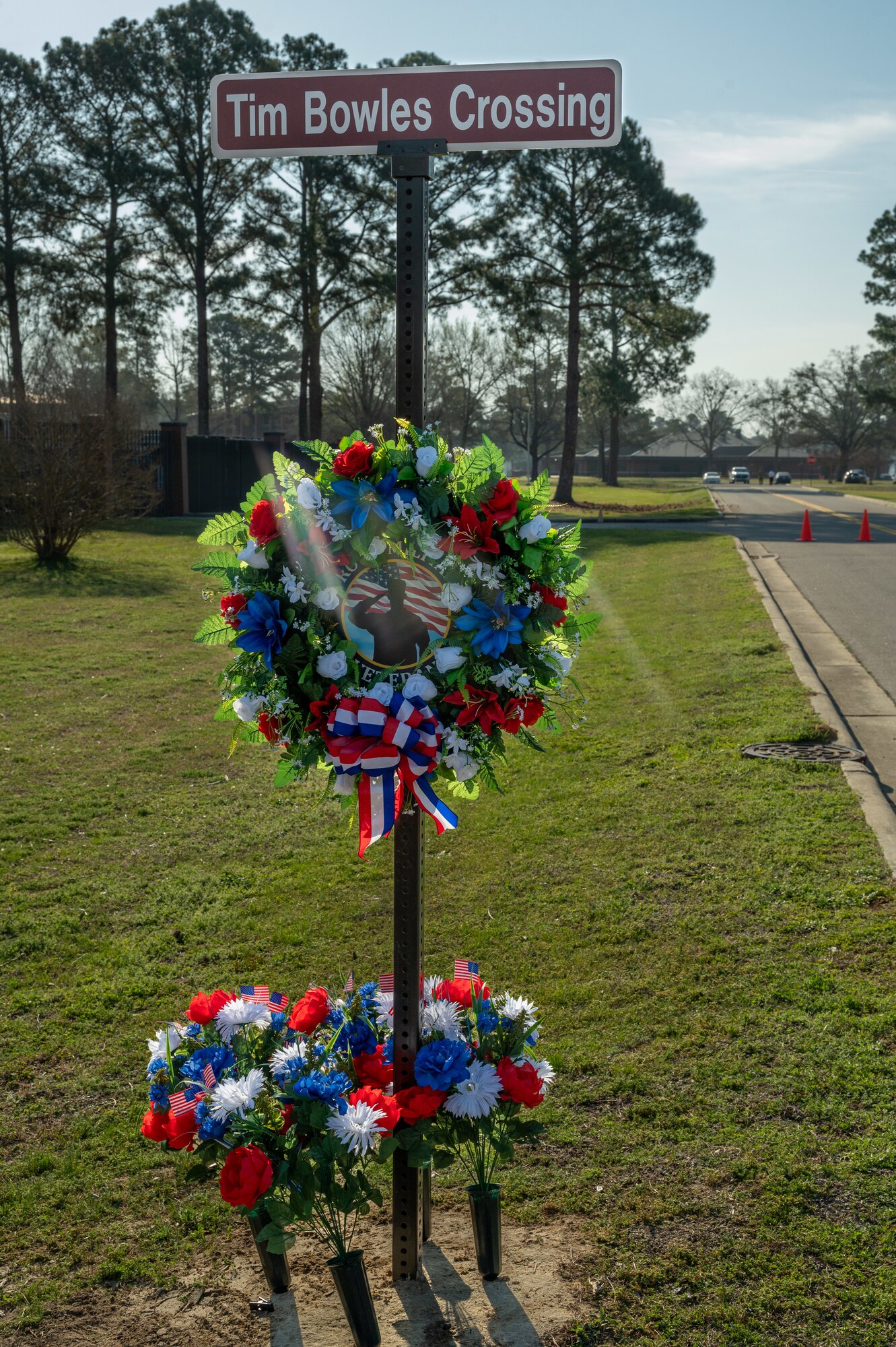 A decorated crosswalk sign honoring the memory of U.S. Air Force Staff Sgt. Timothy Bowles at Seymour Johnson Air Force Base, North Carolina, March 15, 2024. On March 15th, 2009, Sergeant Bowles, who was not scheduled to work, volunteered to take on an ill Airman’s place on patrol. While on patrol near Kot, Afghanistan, Sergeant Bowles’ vehicle encountered an Improvised Explosive Device. As a result of the explosion, Staff Sgt. Bowles suffered fatal wounds. He was posthumously awarded the Purple Heart and Bronze Star. (U.S. Air Force photo by Airman 1st Class Leighton Lucero)