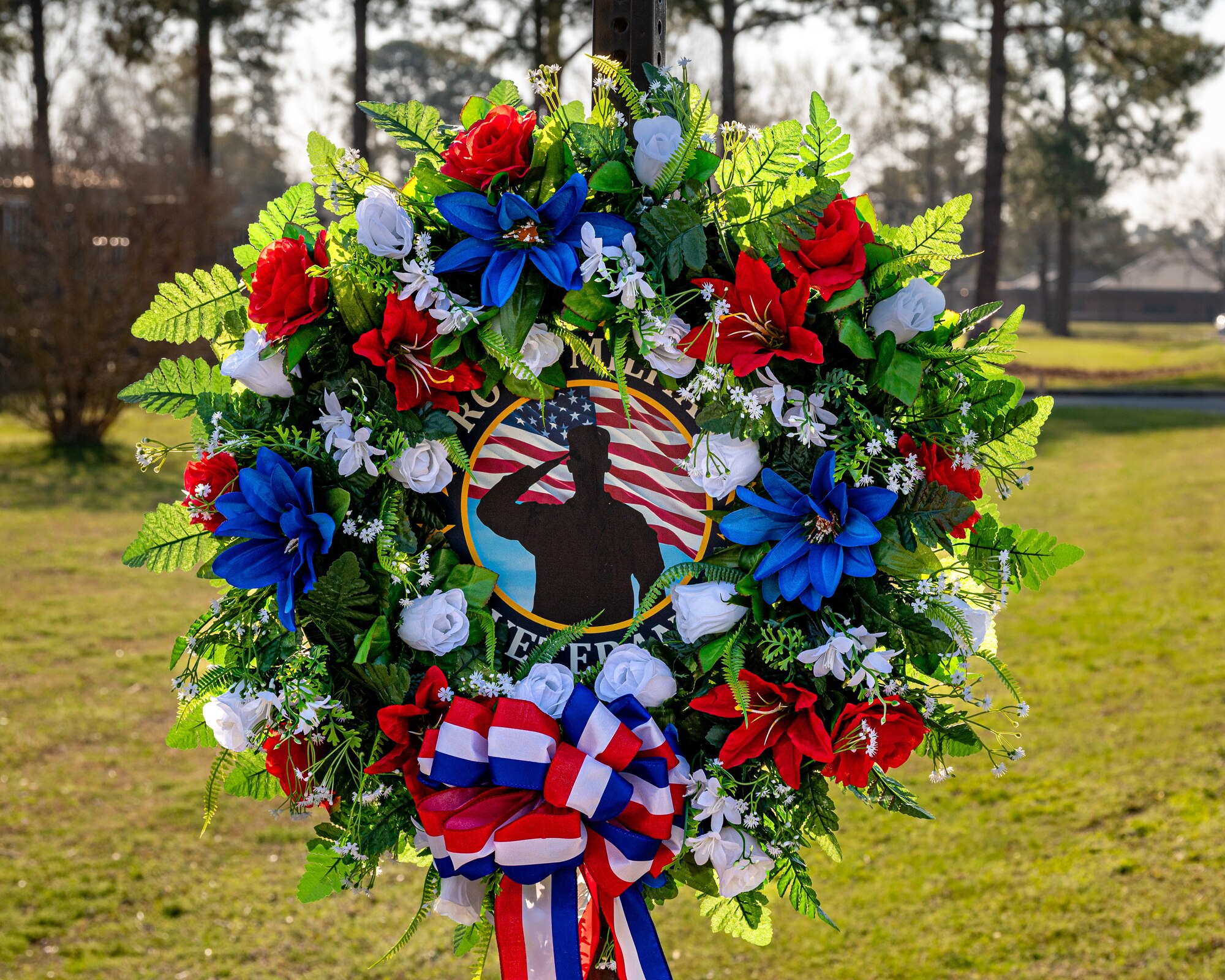 A decorated street sign honoring the memory of U.S. Air Force Staff Sgt. Timothy Bowles at Seymour Johnson Air Force Base, North Carolina, March 15, 2024. For his sacrifice Staff Sgt. Timothy Bowles was posthumously awarded the Purple Heart and Bronze Star. (U.S. Air Force photo by Airman 1st Class Leighton Lucero)