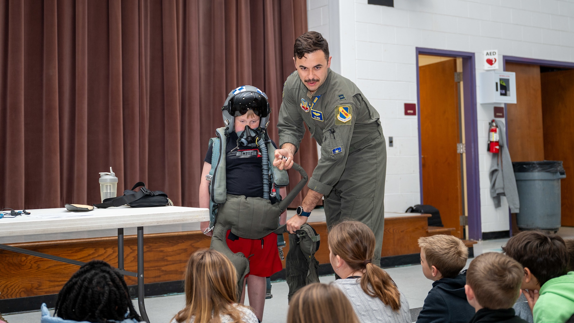 U.S. Air Force Capt. Caleb Moore, a pilot assigned to the 334th Fighter Squadron, performs a demonstration for students during a career fair in Goldsboro, North Carolina, Mar. 27, 2024. At the fair, Airmen from the 4th Fighter Wing showcased their career fields to allow students an opportunity to learn about different specialities within the Air Force. (U.S. Air Force Photo by Airman Rebecca Tierney)
