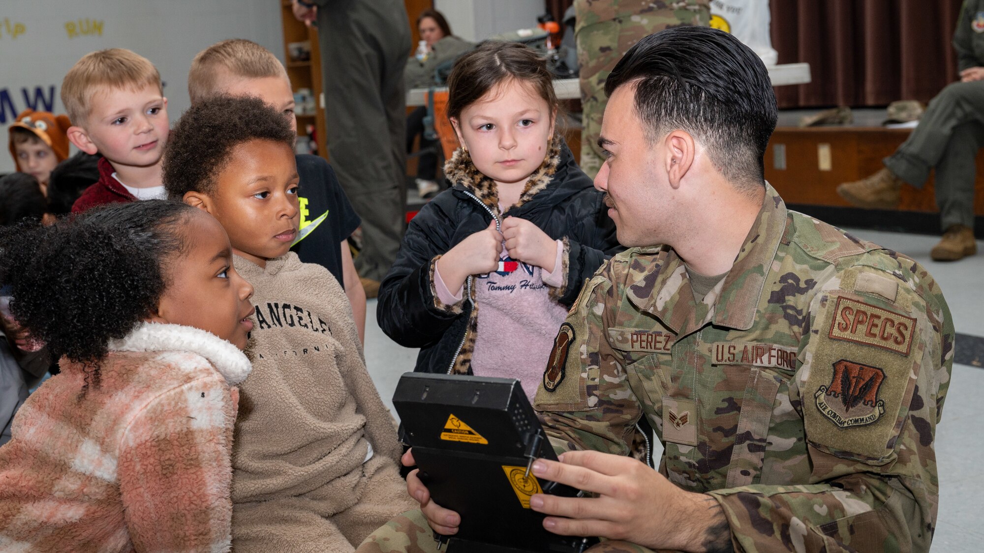 U.S. Air Force Senior Airman Andrew Perez, an avionics technician assigned to the 333rd Fighter Generation Squadron, performs a demonstration for students during a career fair in Goldsboro, North Carolina, Mar. 27, 2024. At the fair, Airmen from the 4th Fighter Wing showcased their career fields to allow students an opportunity to learn about different specialties within the Air Force. (U.S. Air Force Photo by Airman Rebecca Tierney)