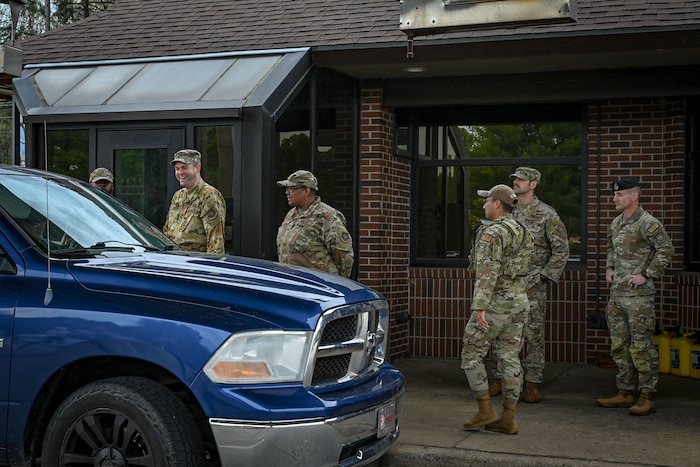 Six Airman stand at a check in point