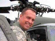 Chief Warrant Officer 5 Bruce McCormick getting into helicopter