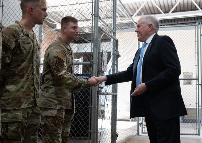 Secretary of the Air Force Frank Kendall coins Team Hickam Airmen.