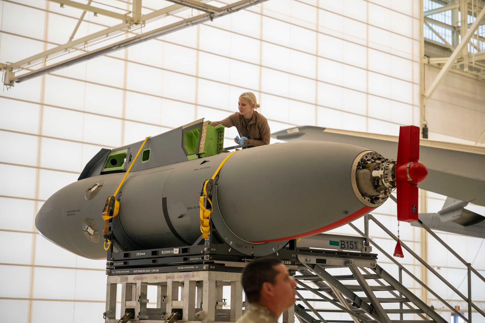 Airman Lacey Wipper, 22nd Aircraft Maintenance Squadron crew chief, applies a solution onto a KC-46A Pegasus Wing Aerial Refueling Pod (WARP) pylon March 5, 2024, at McConnell Air Force Base, Kansas.