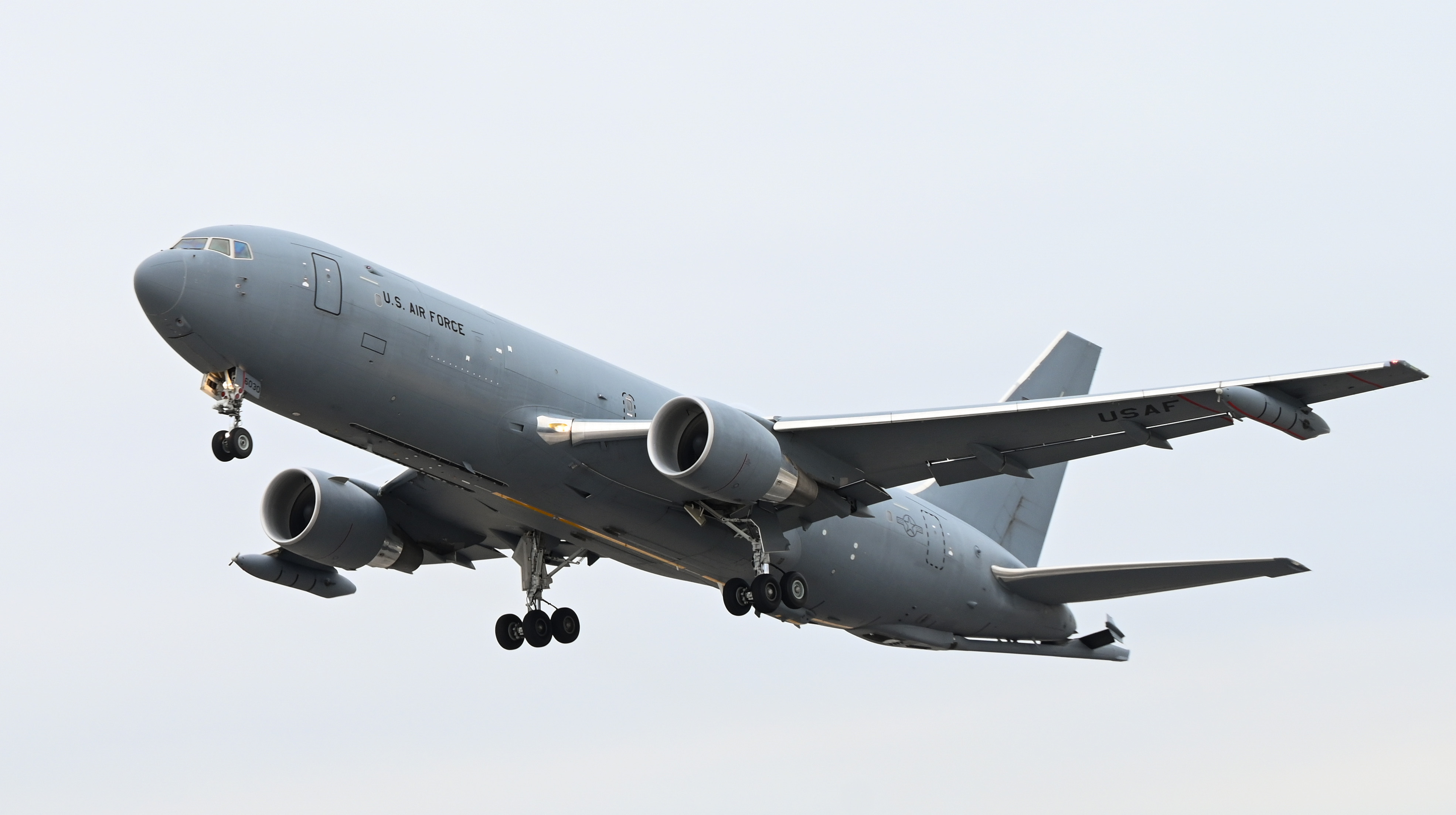 A KC-46A Pegasus with Wing Aerial Refueling Pods attached takes off March 13, 2024, from McConnell Air Force Base, Kansas. This was McConnell’s first test flight with the pods, which allow the KC-46 to refuel two fighter aircraft at once. (U.S. Air Force photo by Staff Sgt. Tryphena Mayhugh)