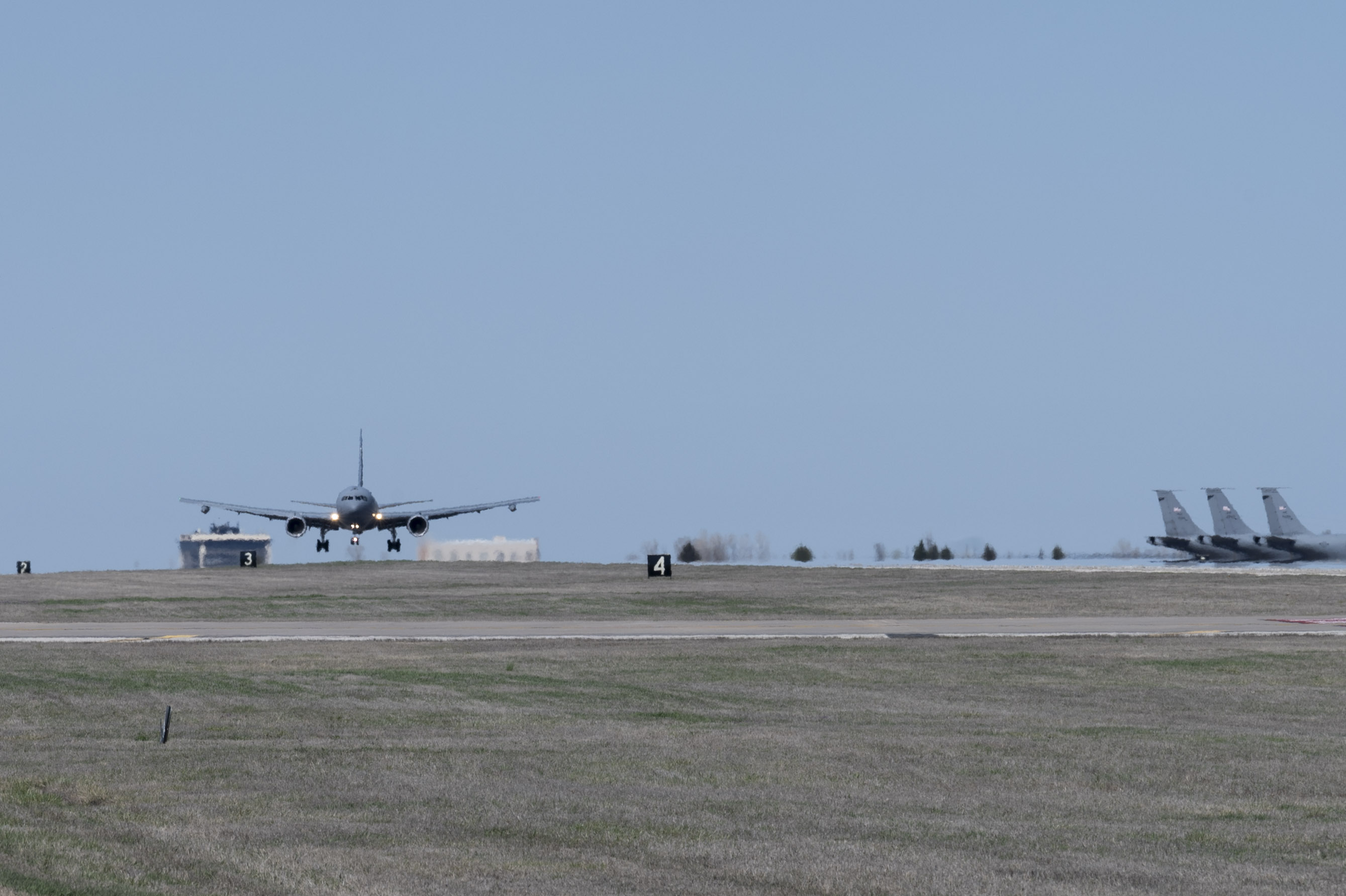 A KC-46A Pegasus, with Wing Aerial Refueling Pods (WARPs) attached, lands on the runway at McConnell Air Force Base, Kansas March 19, 2024. The KC-46 recently finished WARPs refueling with U.S, Navy F/-18 Hornets, which allows the Pegasus to simultaneously refuel two aircraft via drogue chutes. (U.S. Air Force photo by Airman 1st Class Gavin Hameed)
