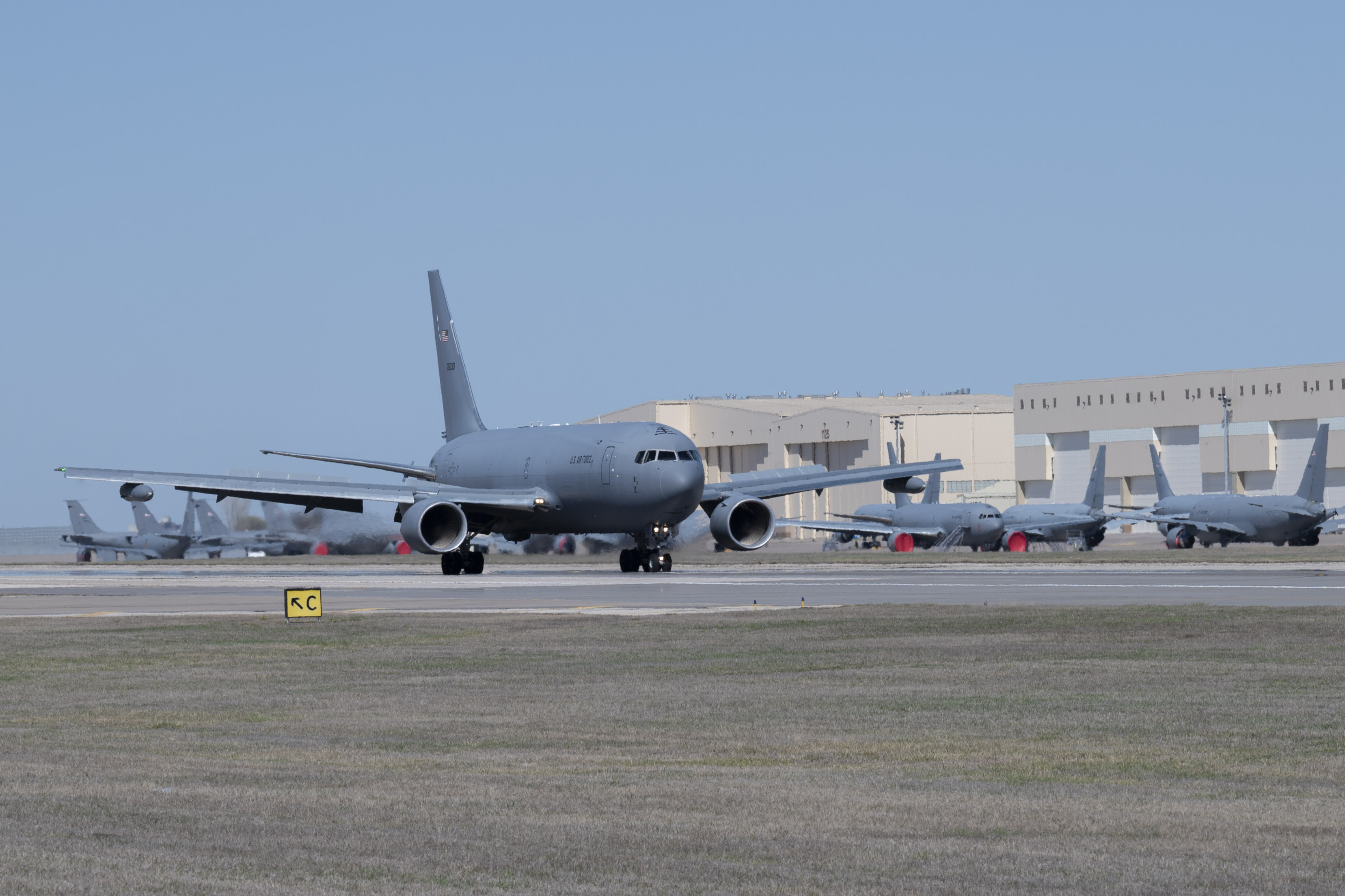 A KC-46A Pegasus, with Wing Aerial Refueling Pods (WARPs) attached, lands on the runway at McConnell Air Force Base, Kansas March 19, 2024. The KC-46 recently finished WARPs refueling with U.S, Navy F/-18 Hornets, which allows the Pegasus to simultaneously refuel two aircraft via drogue chutes. (U.S. Air Force photo by Airman 1st Class Gavin Hameed)