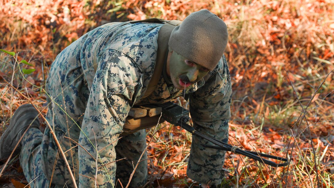 U.S. Marine Corps Lance Cpl. Robert Parish, a student with Scout Sniper Course, School of Infantry-East, reacts to a simulated chemical attack during a training event at Marine Corps Base Camp Lejeune, North Carolina, Nov. 12, 2023. This course marks the last iteration of the Scout Sniper Course at the School of Infantry-East, which has trained Marines and other service members in long-range precision fires and field craft necessary to provide reconnaissance and surveillance to commanders in support of combat operations.  (U.S. Marine Corps photo by Cpl. Jose’ D. Cruz)