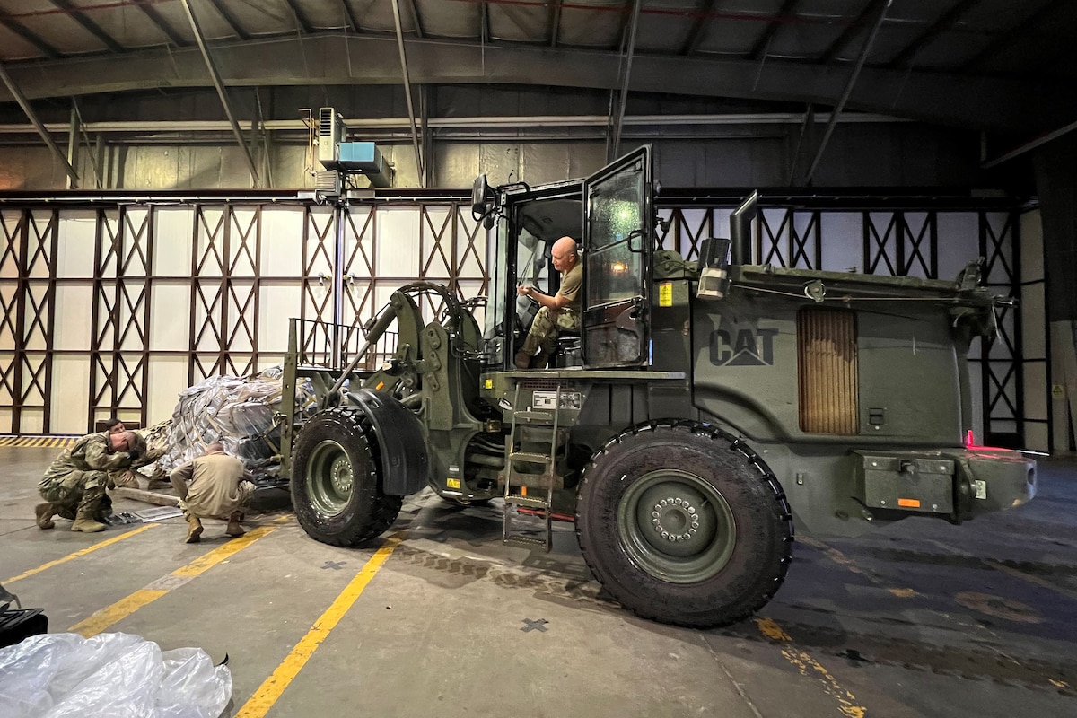 Master Sgt. Jerome Noltemeyer of the Kentucky Air National Guard’s 123rd Airlift Wing positions a cargo pallet for weighing at Ramstein Air Base, Germany, Nov. 16, 2023 in support of Silver Arrow. The program, administered by U.S. Air Forces in Europe, provides funding and mission requirements to build readiness and validate C-130 elements throughout the Force Generation deployment cycle. (U.S. Air National Guard photo by Lt. Col. Jennifer Nash)