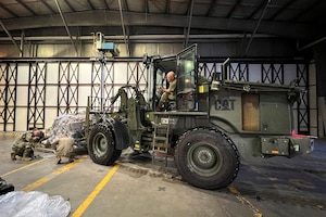 Master Sgt. Jerome Noltemeyer of the Kentucky Air National Guard’s 123rd Airlift Wing positions a cargo pallet for weighing at Ramstein Air Base, Germany, Nov. 16, 2023 in support of Silver Arrow. The program, administered by U.S. Air Forces in Europe, provides funding and mission requirements to build readiness and validate C-130 elements throughout the Force Generation deployment cycle. (U.S. Air National Guard photo by Lt. Col. Jennifer Nash)