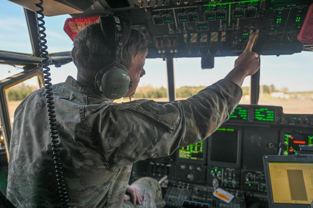 An Airman operates controls on an aircraft