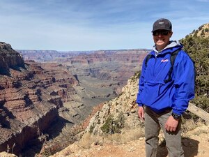 Image of 1st Lt. Nathan Collins posing outdoors near a mountain gorge.