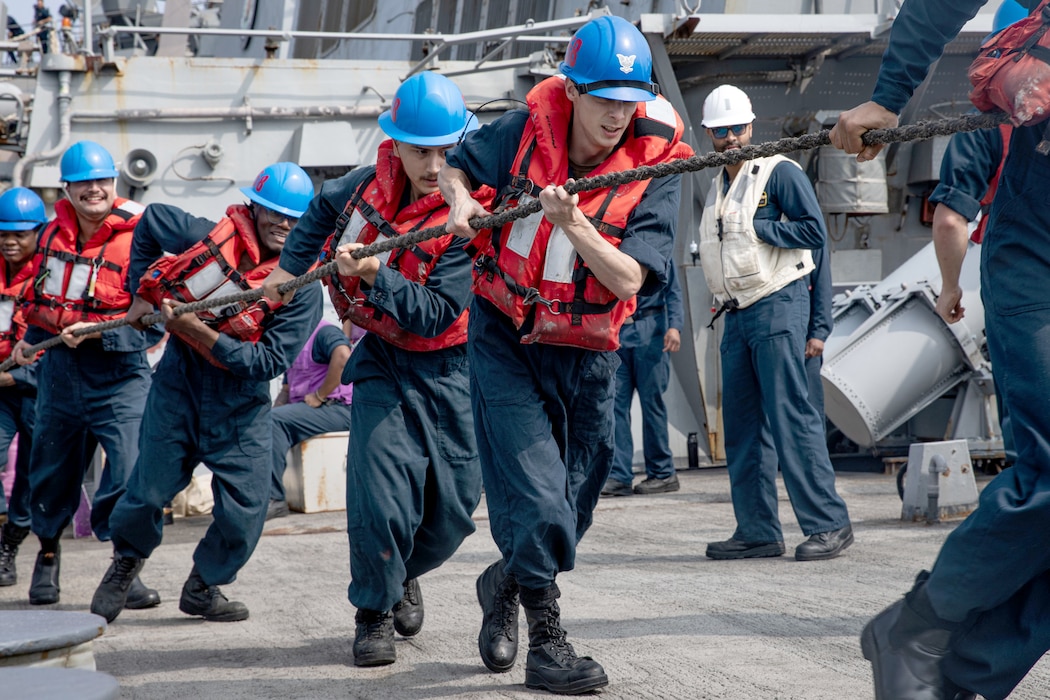 Sailors heave line aboard USS Carney (DDG 64) during a replenishment with USNS Kanawha (T-AO 196) in the Red Sea.