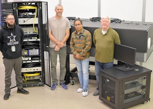 From left: Dominick Fasulo, BAE facilities specialist; Chuck Dahl, BAE electrical engineer; Debashis Satpathi, Government Radiometrically-Accurate Instrument for Laser Evaluation Version II, or GRAILE-II, program manager; and Ian Lee, GRAILE-II technical lead at BAE Systems, before transporting GRAILE-II to the Air Force Research Laboratory for system acceptance, ‎Feb. ‎27, ‎2024. The GRAILE-II diagnostic system will be used to validate the performance of the Department of Defense’s most powerful high-energy laser systems. (Courtesy photo / Gina Schreiner)