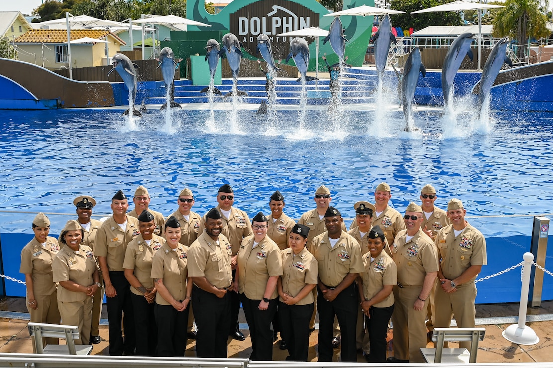 Sailor of the Year (SOY) candidates and their Chief Petty Officers take a picture with the dolphins at the SeaWorld in San Diego during a three-day Sailor of the Year (SOY) tour, March 28, 2024. The Sailors were all selected as their installation's Sailor of the Year and were in San Diego to compete for the title of Navy Region Southwest SOY. The Sailor selected as the Navy Region Southwest SOY will compete against the other regional SOYs to become Commander, Navy Installation Command's SOY and earn a meritorious promotion to Chief Petty Officer. (U.S. Navy photo by Mass Communications Specialist 3rd Class Victoria Danser)