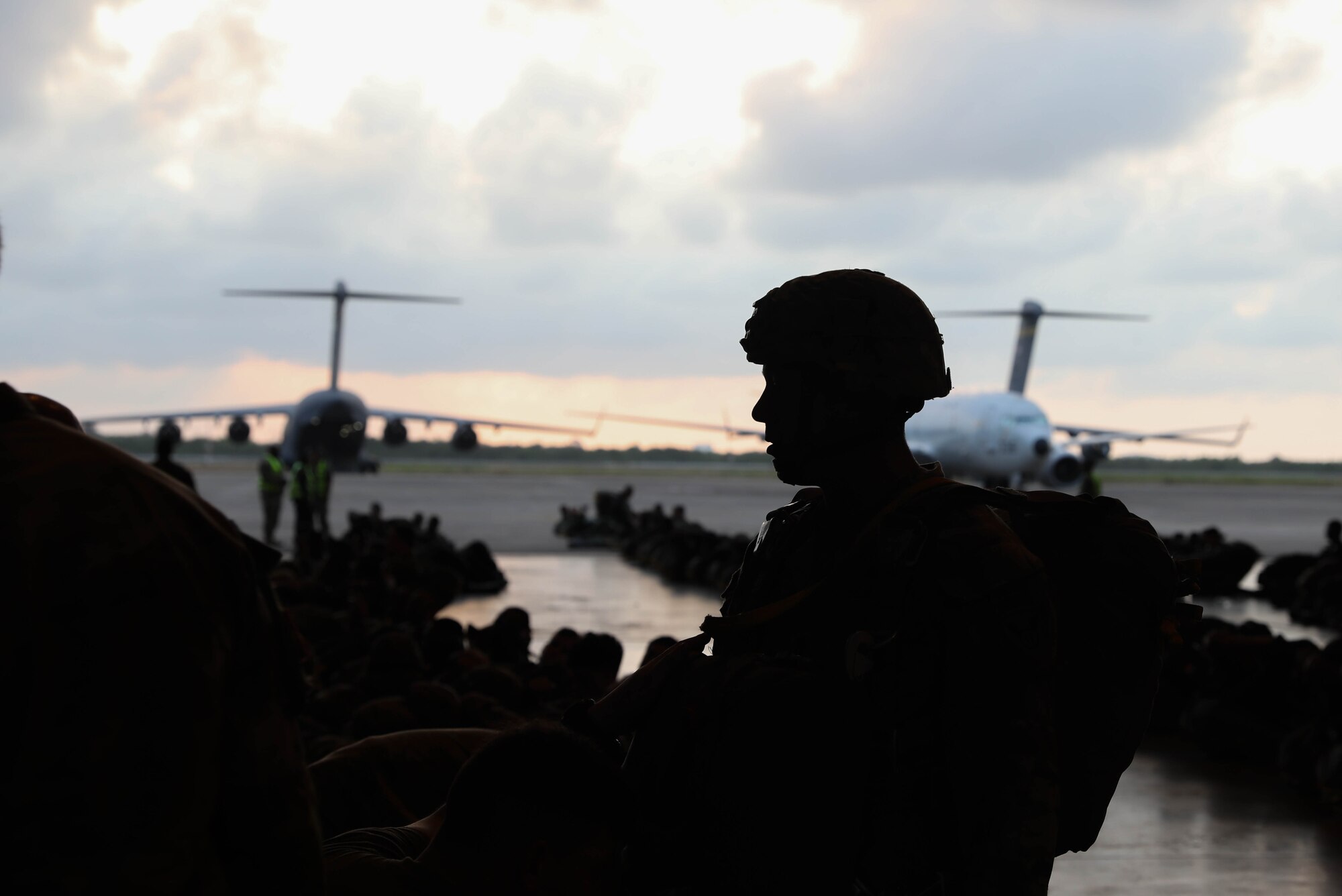 A photo of a man's silhouette on a flightline during an exercise.